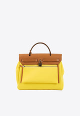 حقيبة هيرباغ زيب 31 من قماش توال بلون جون سيترون وجلد هانتر بلون ناتشورال سابل مع أجزاء معدنية فضية